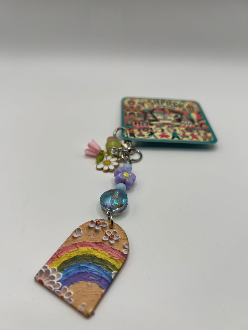 Oval top window with rainbow, colored beads and purple flower charm