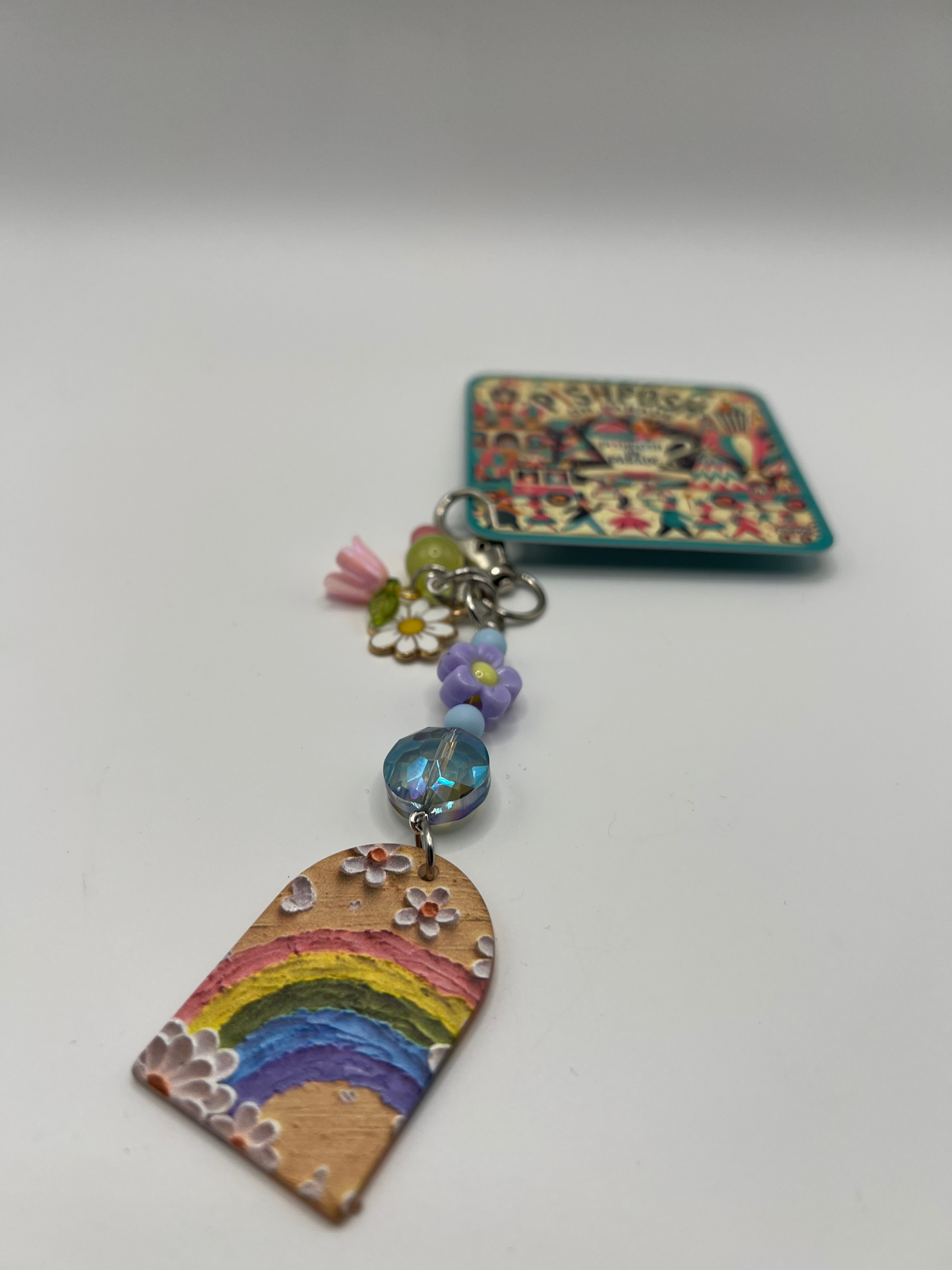Oval top window with rainbow, colored beads and purple flower charm