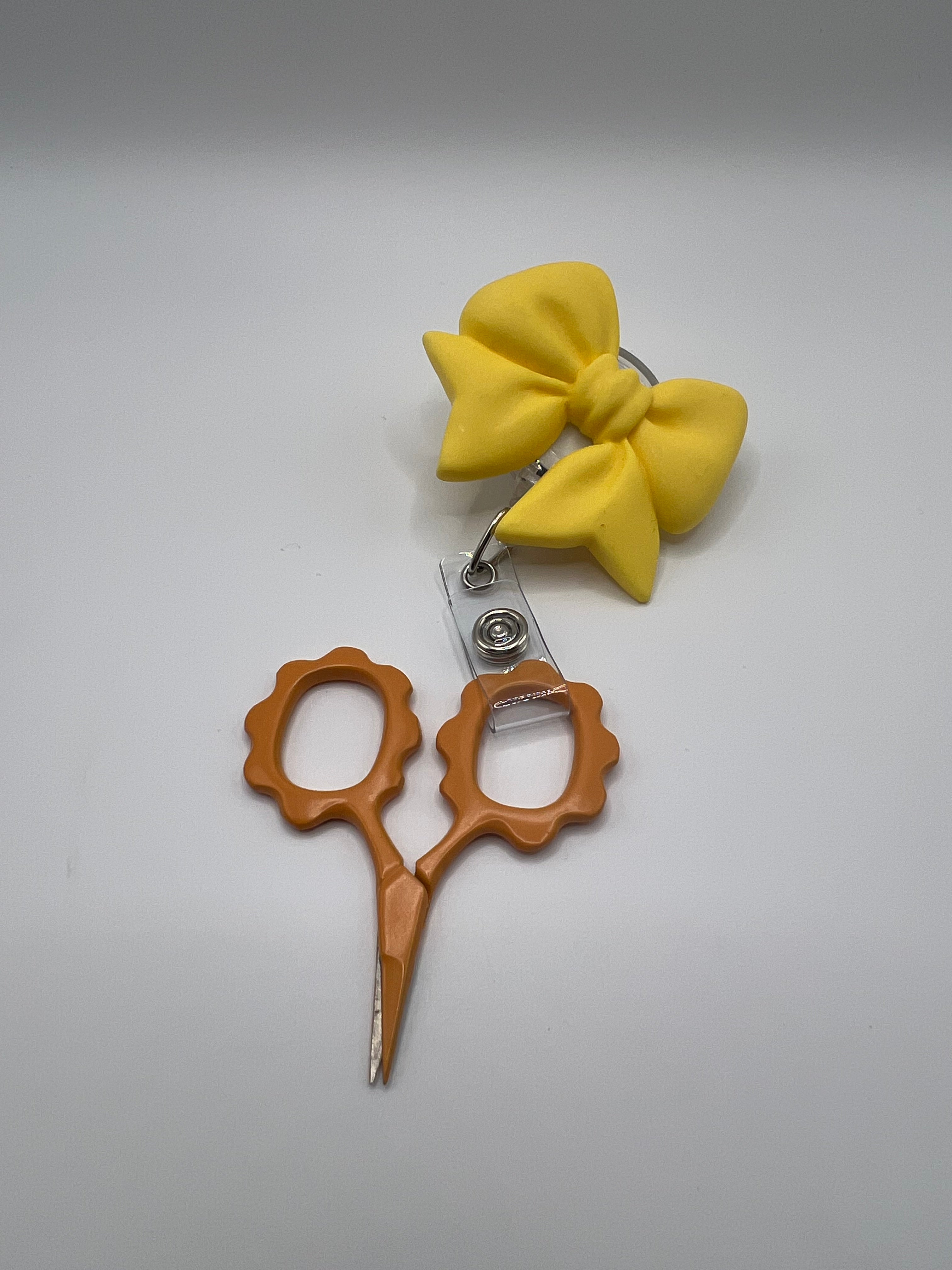 Yellow Bow Badge reel for scissors or badge.  Scissors not included