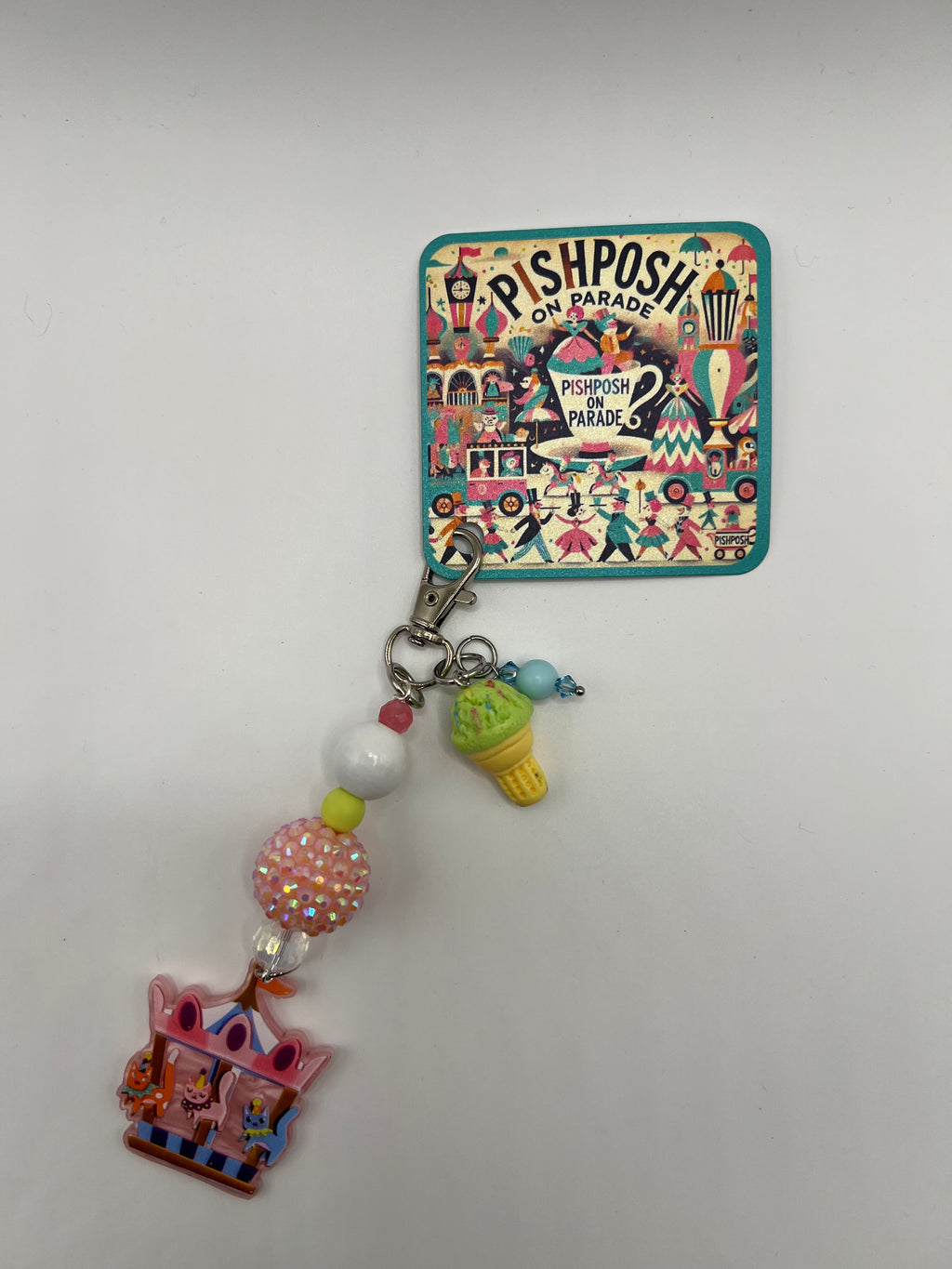 Cats on a carousel with green ice cream charm