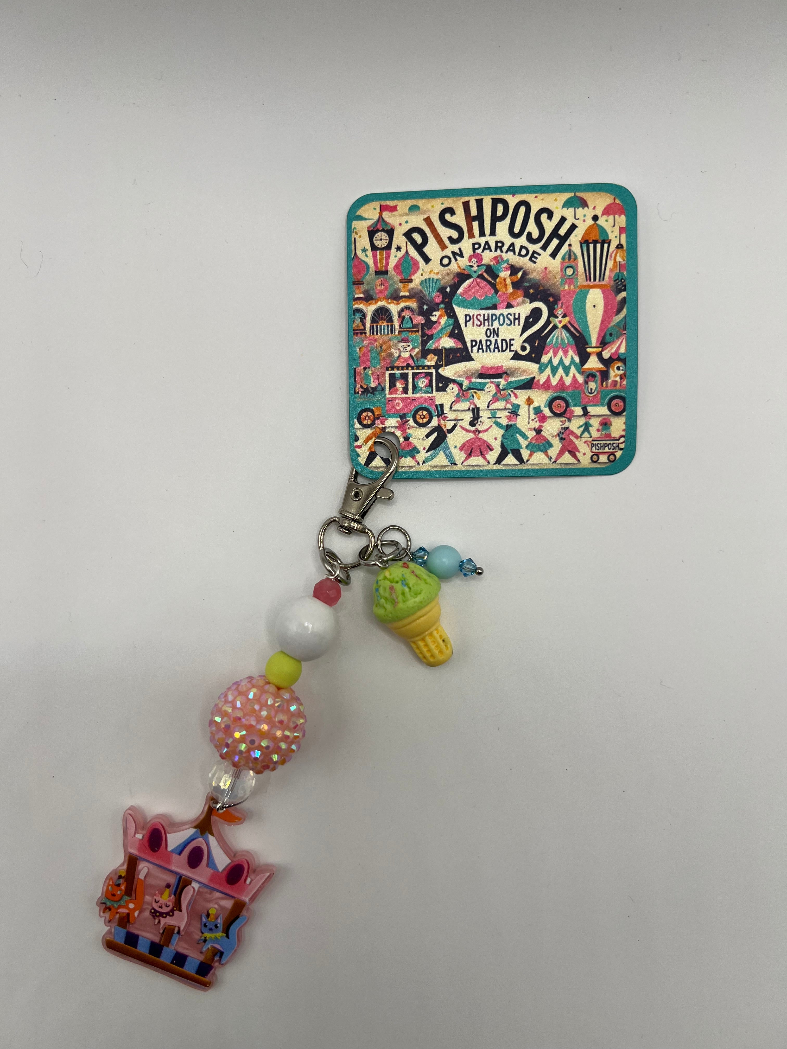 Cats on a carousel with green ice cream charm