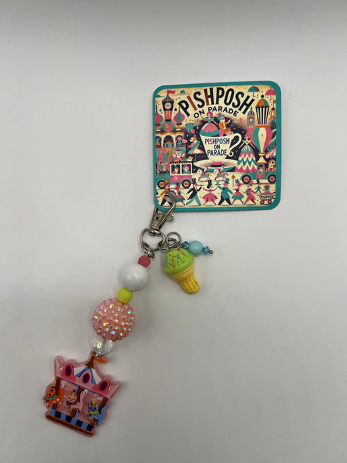 Cats on a carousel with green ice cream charm