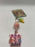 Cats on a carousel with green ice cream charm