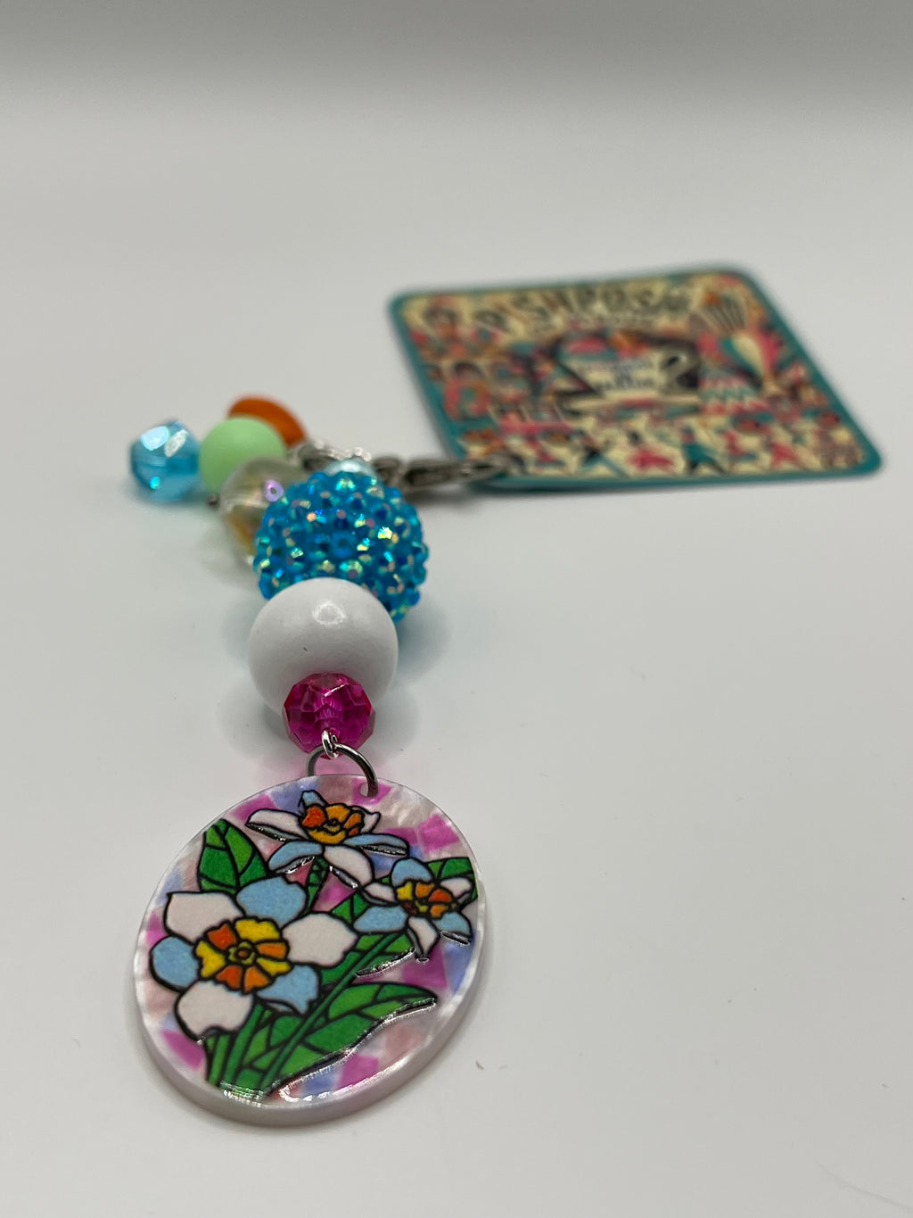 Oval shaped flowers with Blue white and pink beads charm