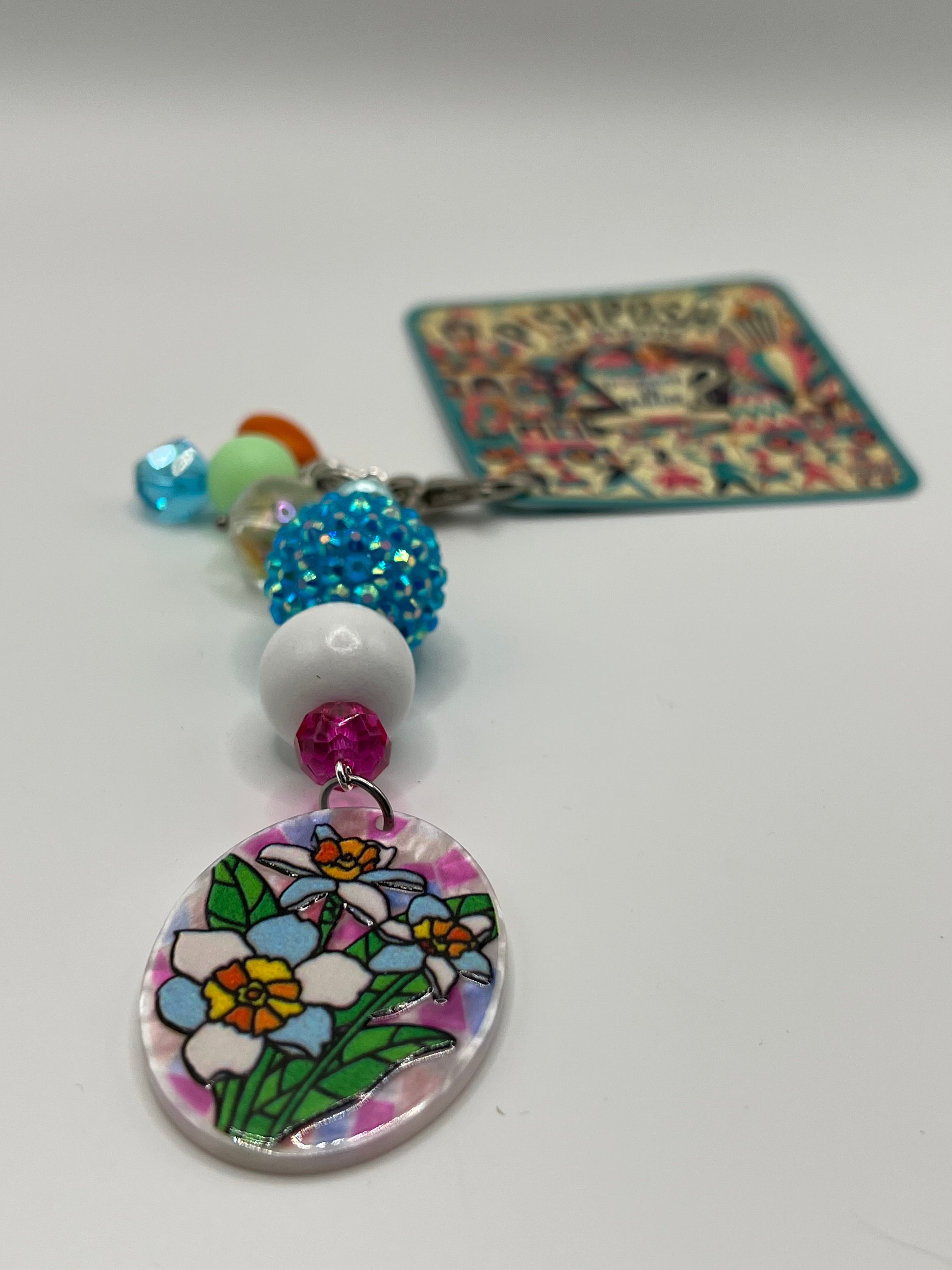 Oval shaped flowers with Blue white and pink beads charm