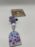 Purple window with crescent charm