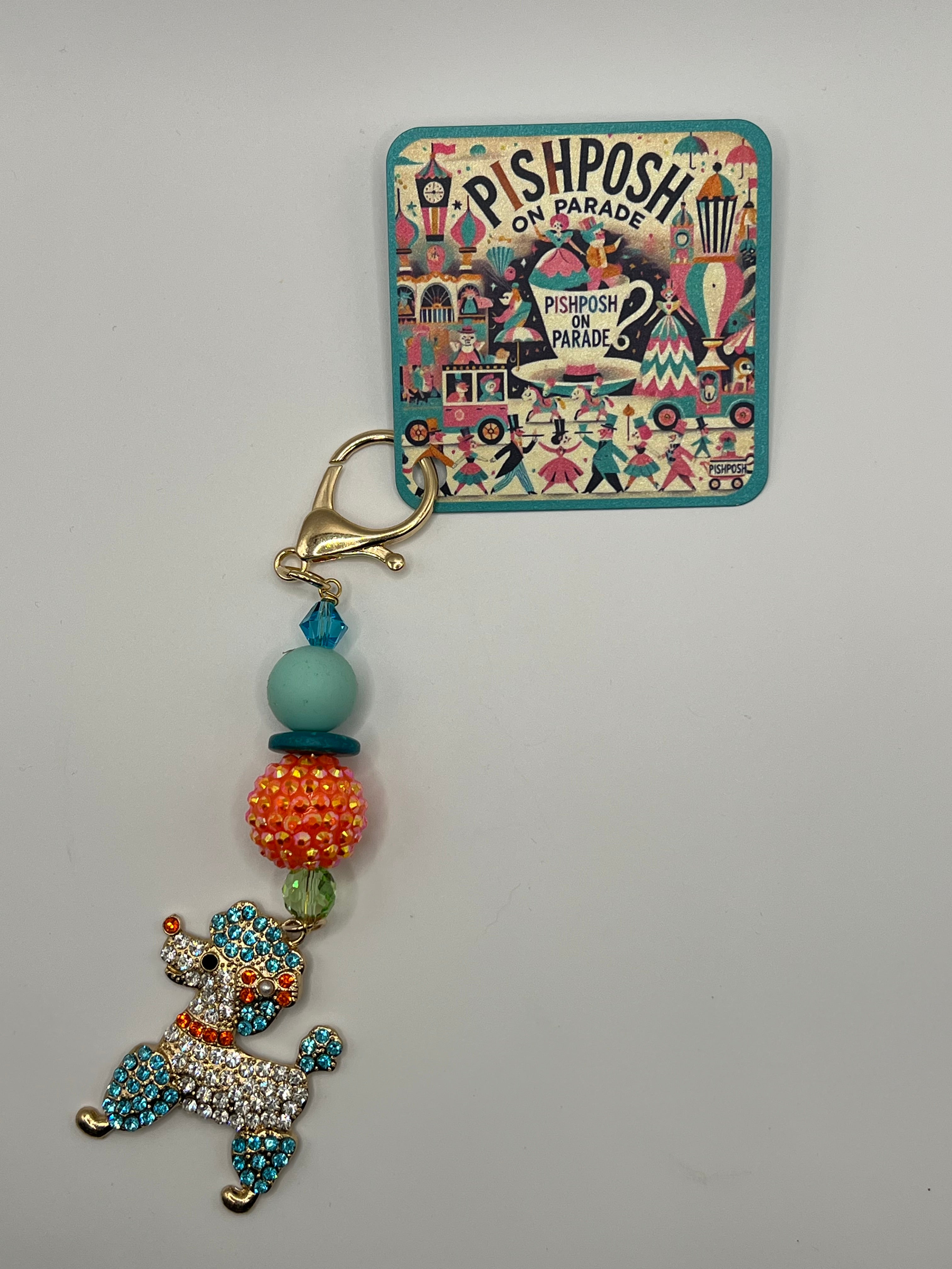 Multi-colored poodle with orange bead charm