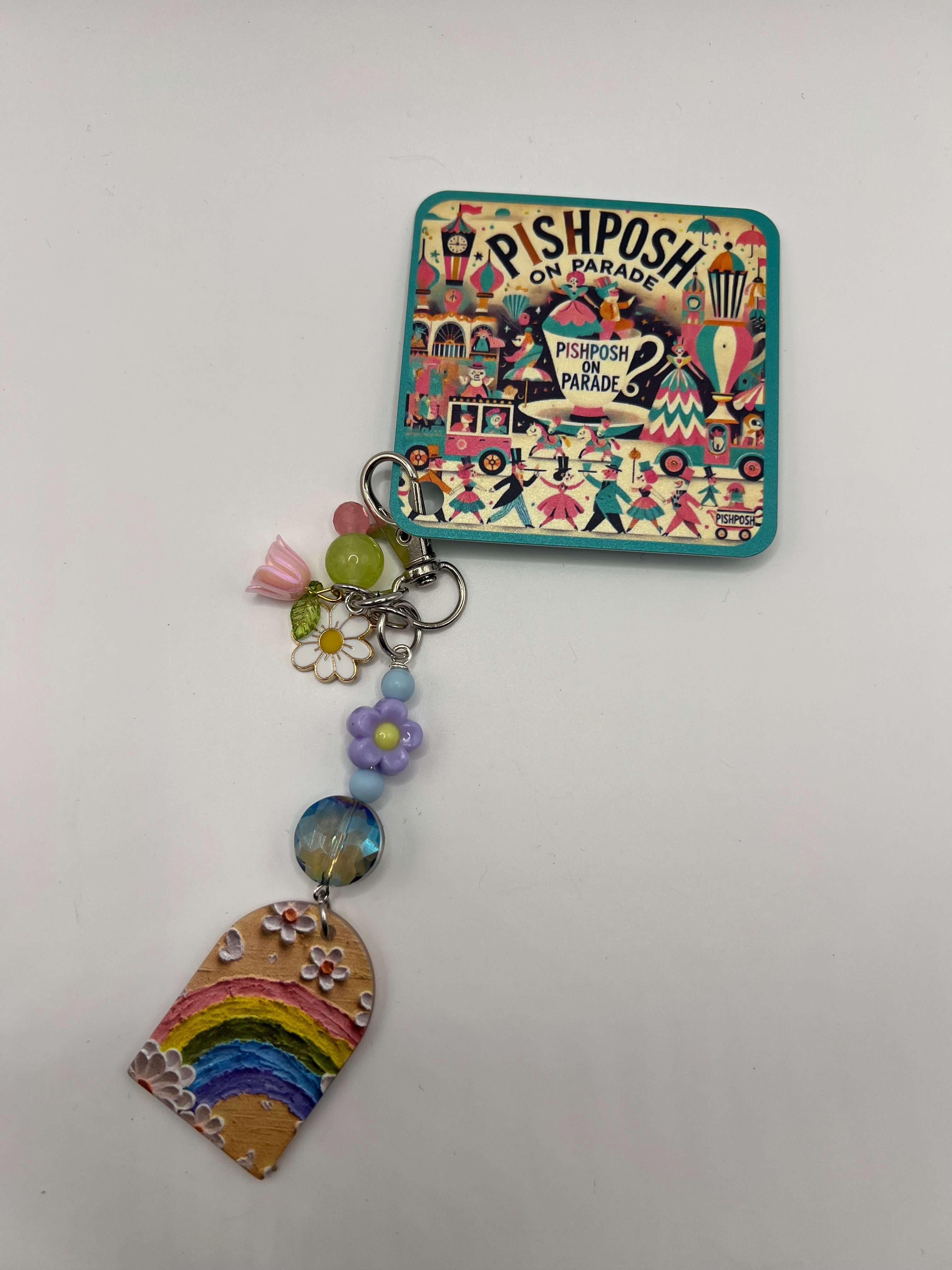Oval top window with rainbow, colored beads and purple flower charm