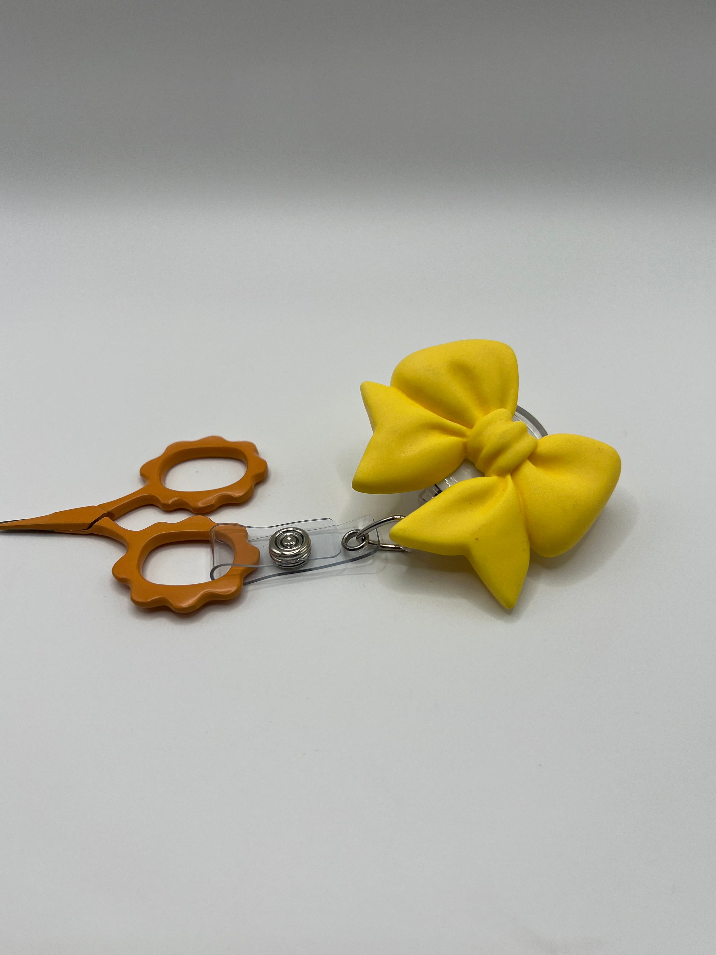 Yellow Bow Badge reel for scissors or badge.  Scissors not included