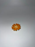 Orange flower needle minder