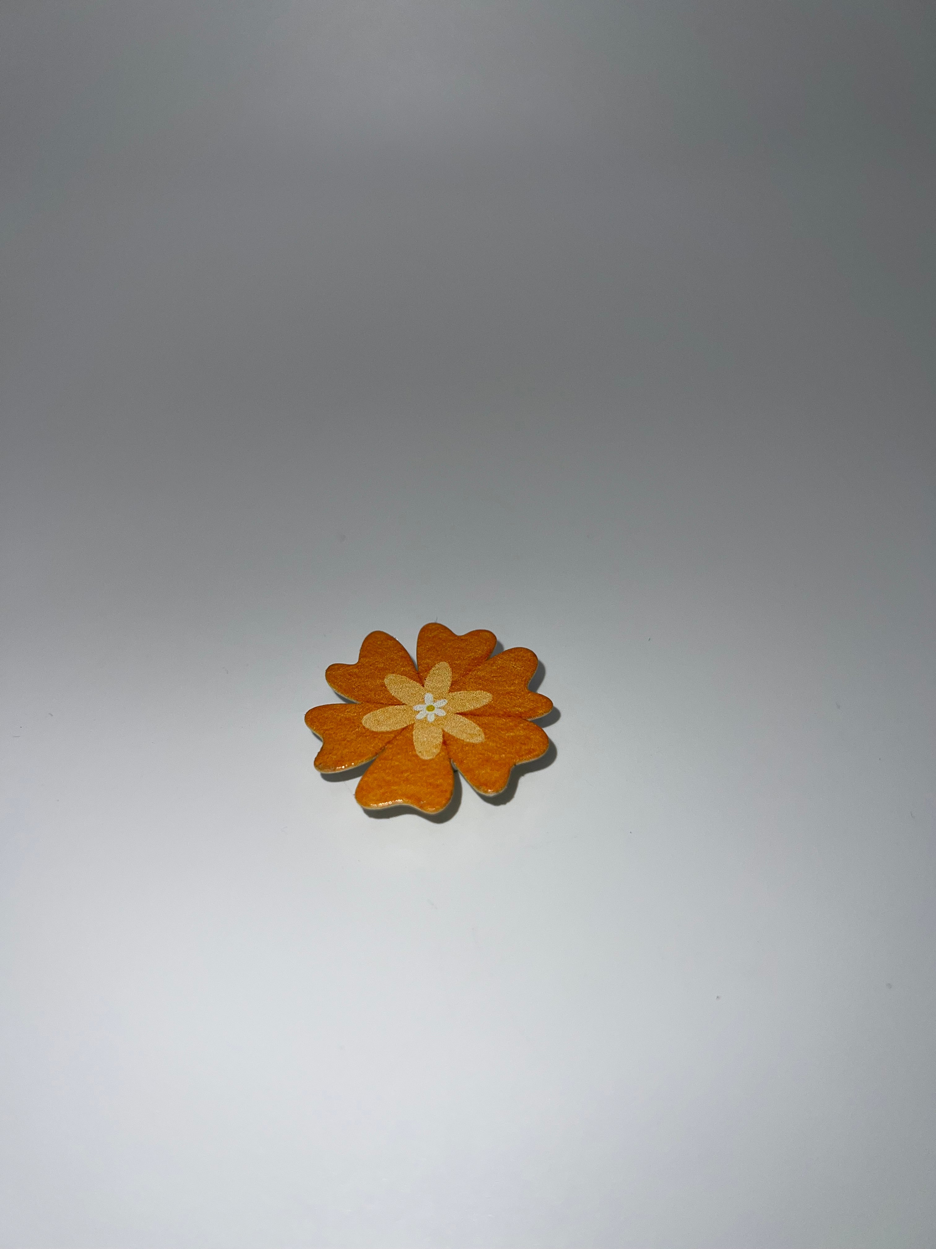 Orange flower needle minder