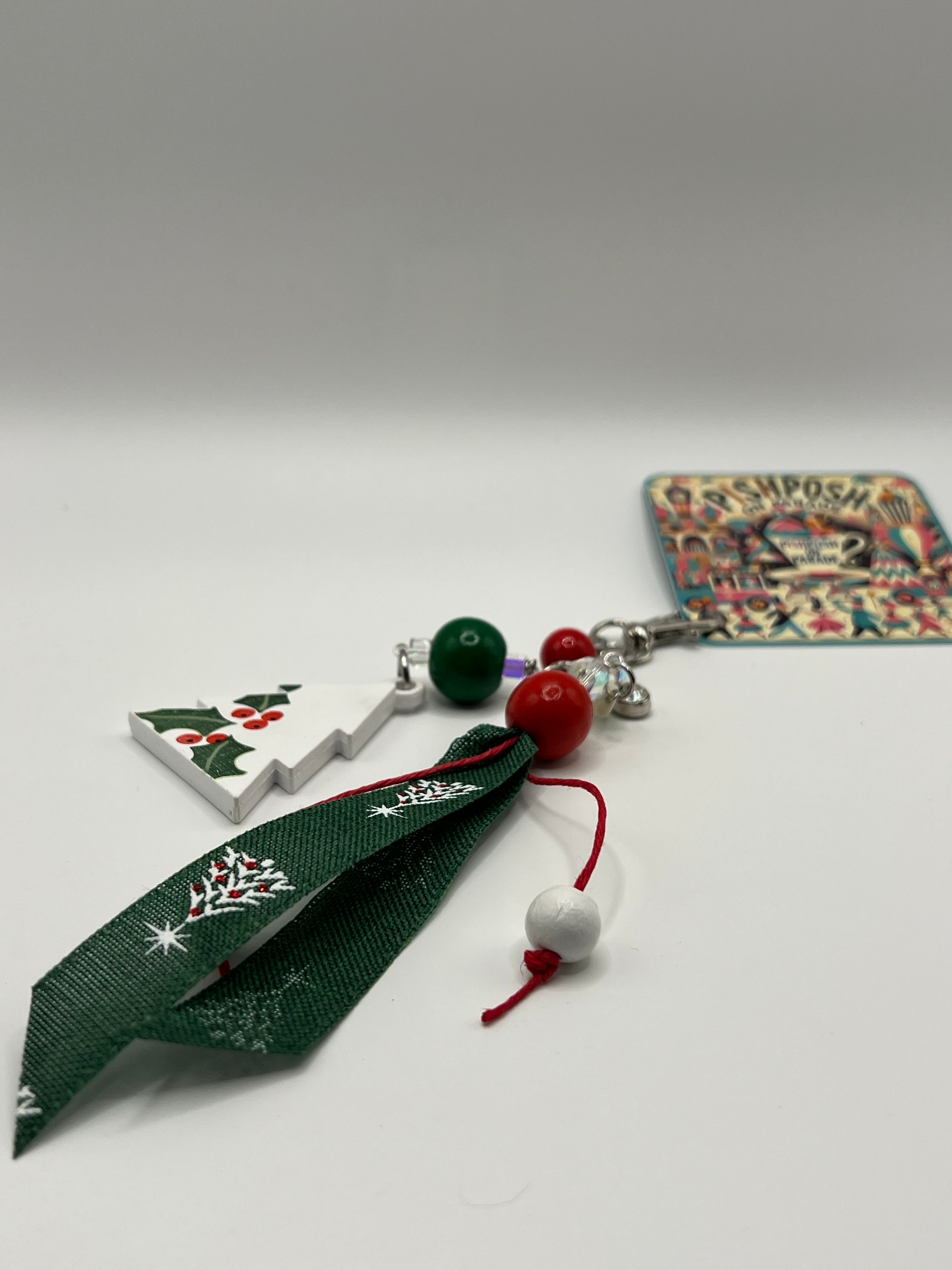 White Christmas tree with holly, green and red beads and green decorative ribbon - Charm / Bag Zipper Pull
